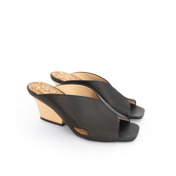 Black faux-leather mule slide with a curved design high heel in light brown wood.